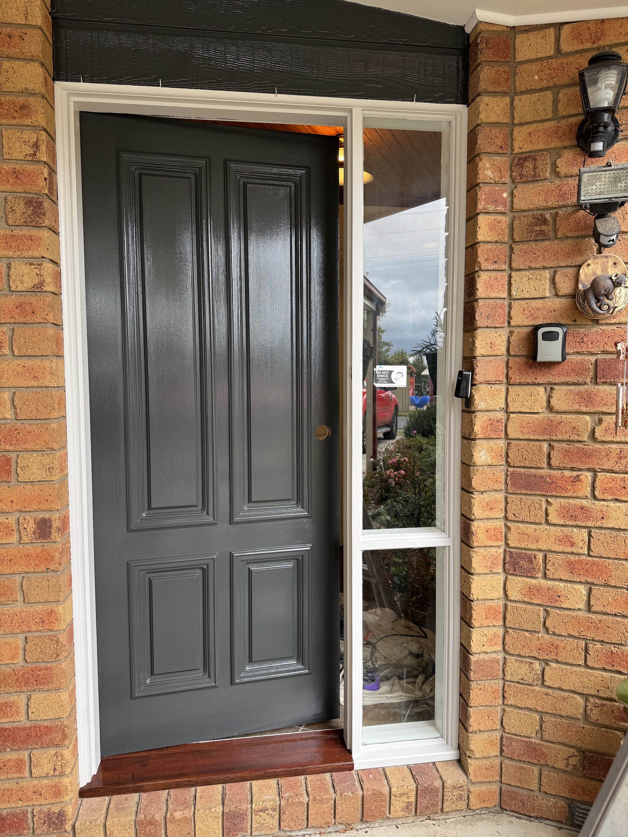 Freshly painted charcoal front door with a crisp white frame